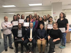 Photo of class of Fall 2018 holding certificates with Poney Chiang