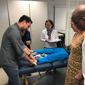 Instructor Ryan Tze-Wai Longenecker teaches participants on lower extremity conditions