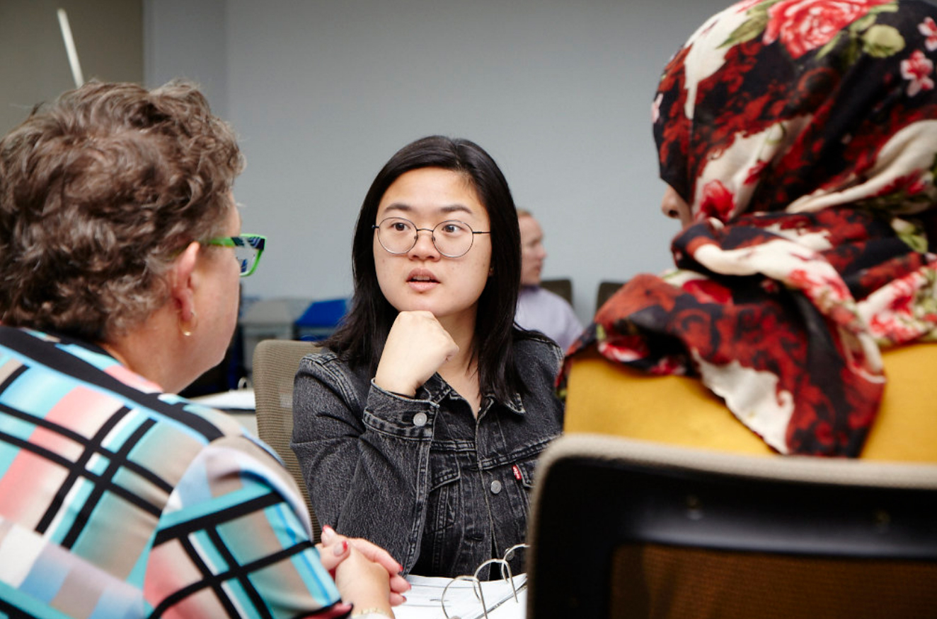 Adult learners sitting together and having a conversation